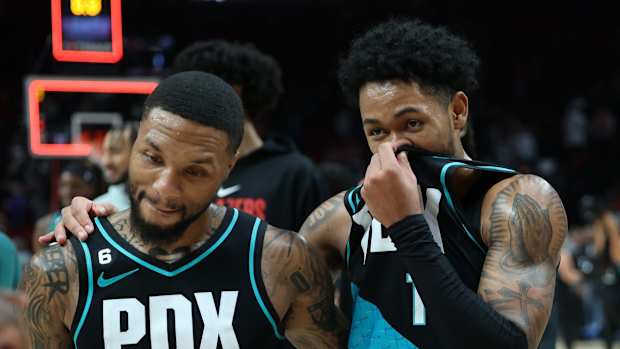 Nov 15, 2022; Portland, Oregon, USA; Portland Trail Blazers guard Damian Lillard (0) and guard Anfernee Simons (1) celebrate after 117-110 win over San Antonio Spurs at Moda Center. Mandatory Credit: Jaime Valdez-USA TODAY Sports